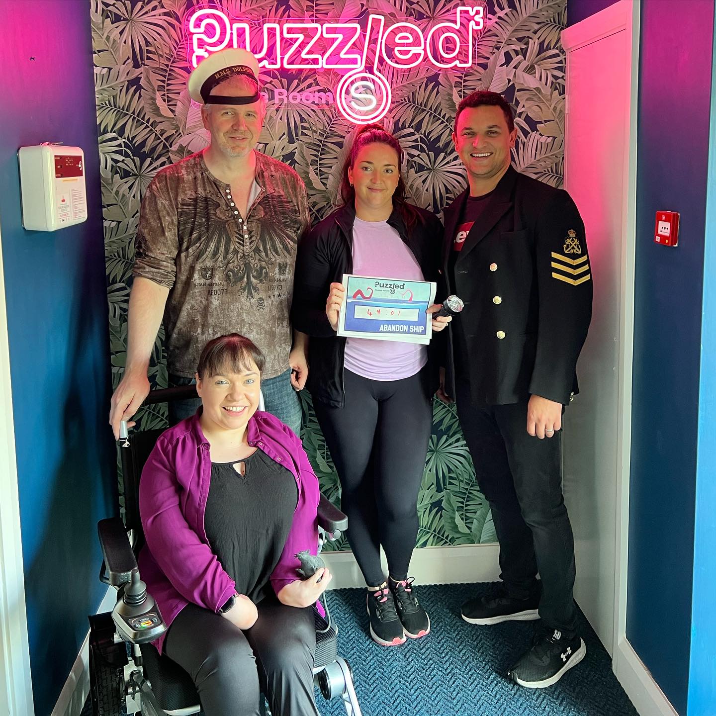 Team Photo of players at Puzzled Escape Rooms including a wheelchair user