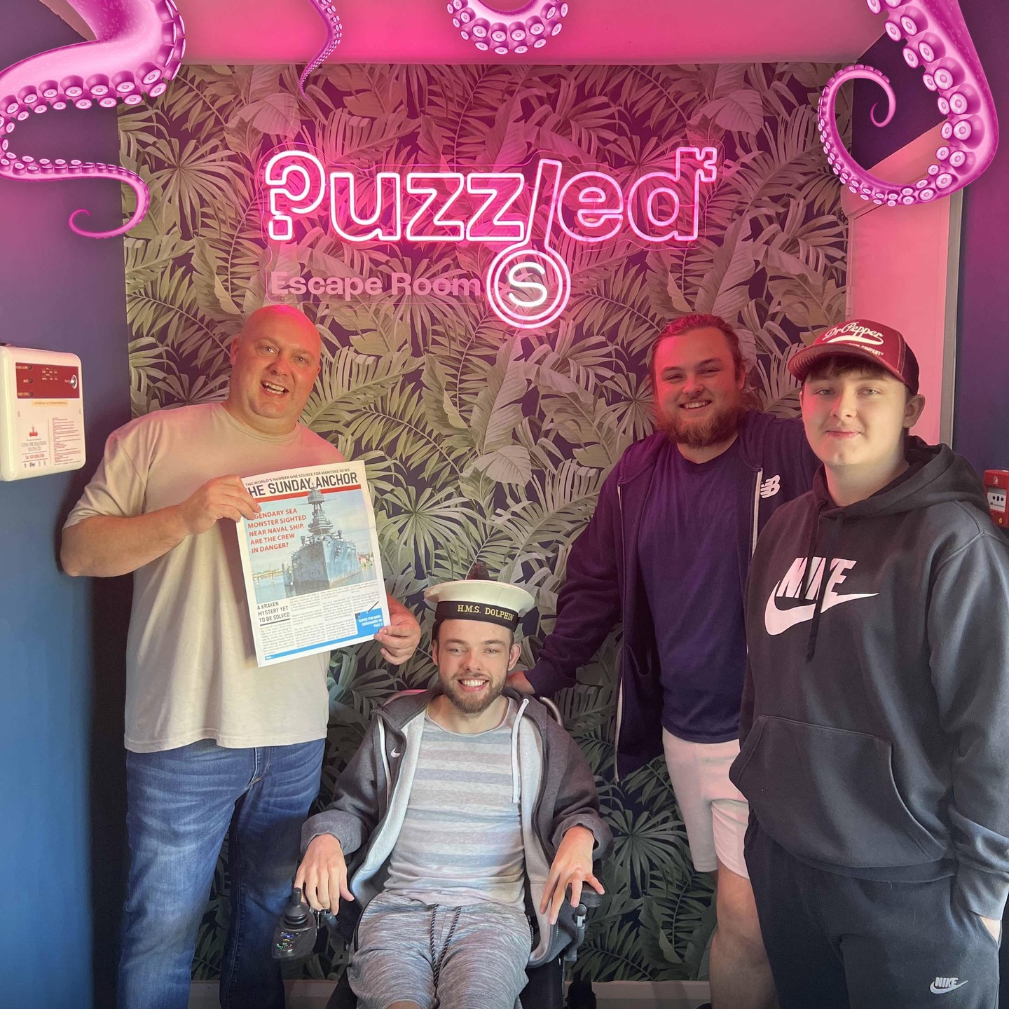 Team Photo of players at Puzzled Escape Rooms including a wheelchair user